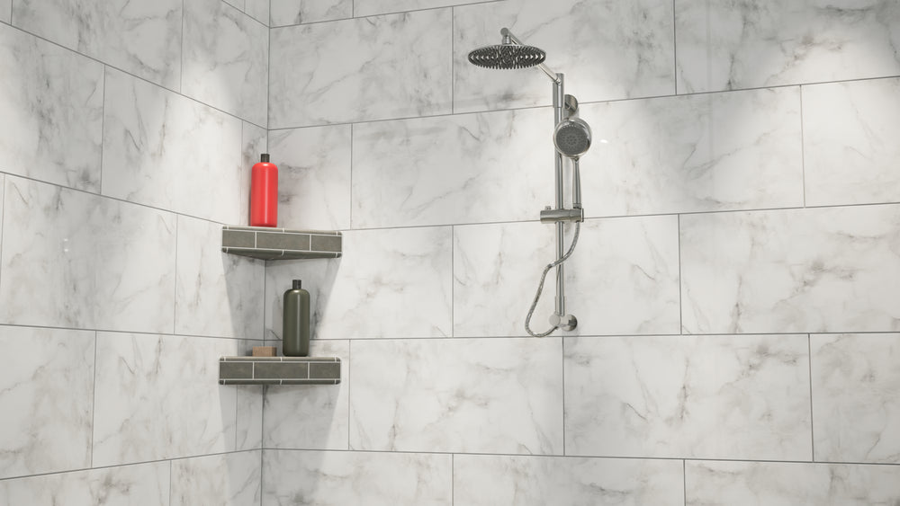 
                  
                    A wide view of a white-marbled standing shower with a rainfall shower head mounted on the wall next to an original corner shower shelf covered in gray tile while holding a red shampoo bottle, a gray conditioner bottle and a bar of soap. 
                  
                