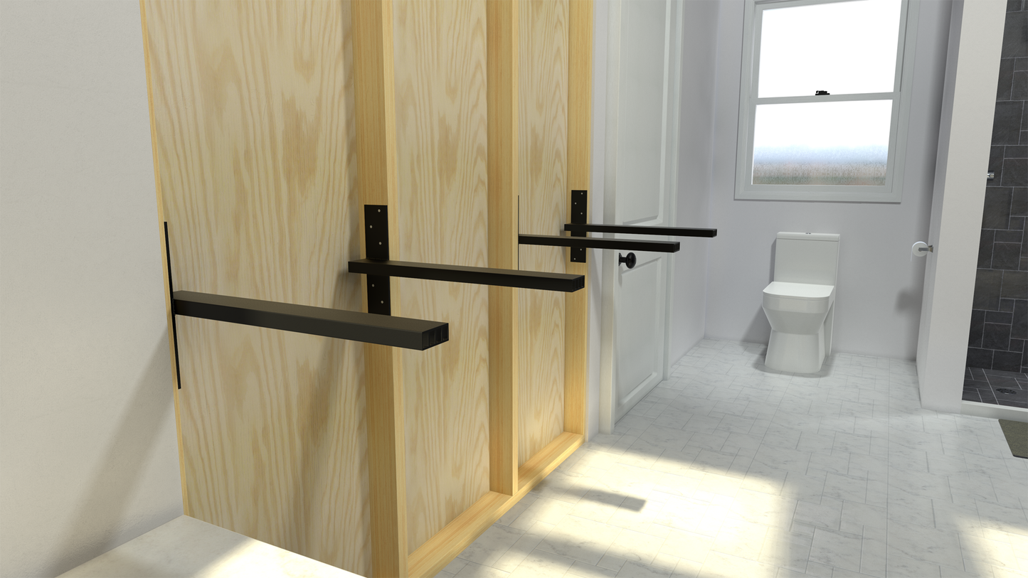 4 Black Original Free Floating Vanity Brackets secured to an unfinished wooden bathroom wall in a white bathroom with a window in the background.
