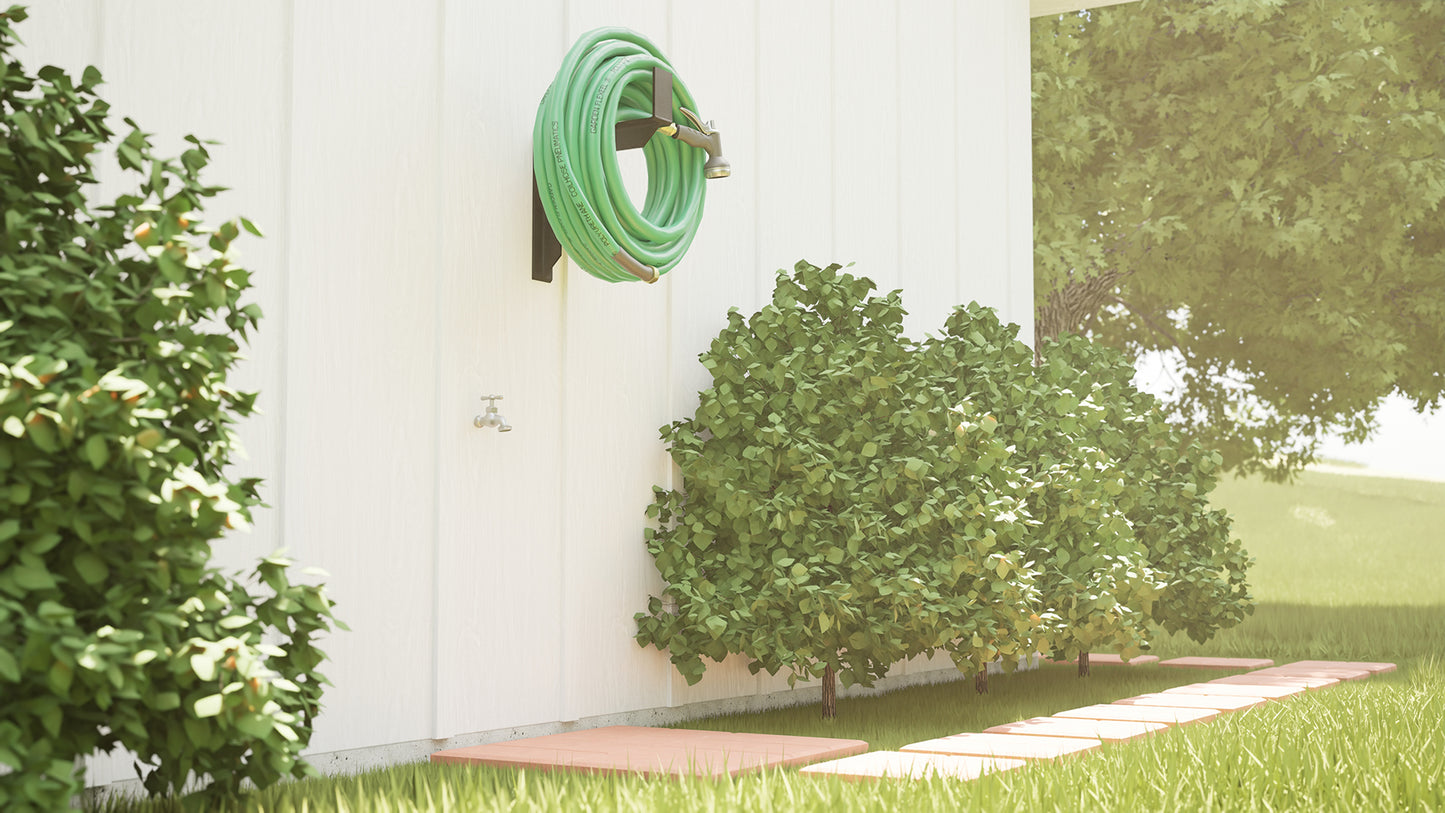
                  
                    A green hose hanging from The Original Granite Bracket’s heavy-duty hose hanger bracket above three green hedges with a tree in the background.
                  
                
