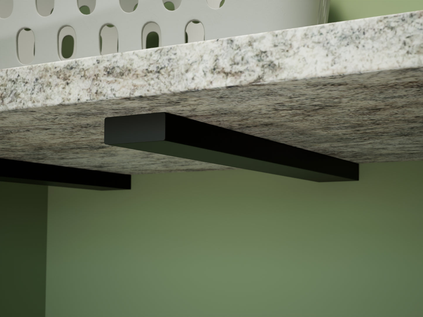 Close up view of an industrial free hanging shelf bracket holding a granite countertop holding a white laundry basket
