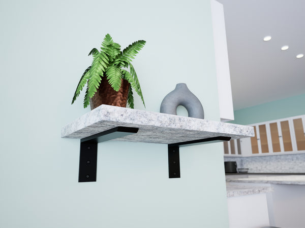 A floating shelf with a marble-like appearance supported by a black metal bracket, featuring a potted plant and a decorative object.