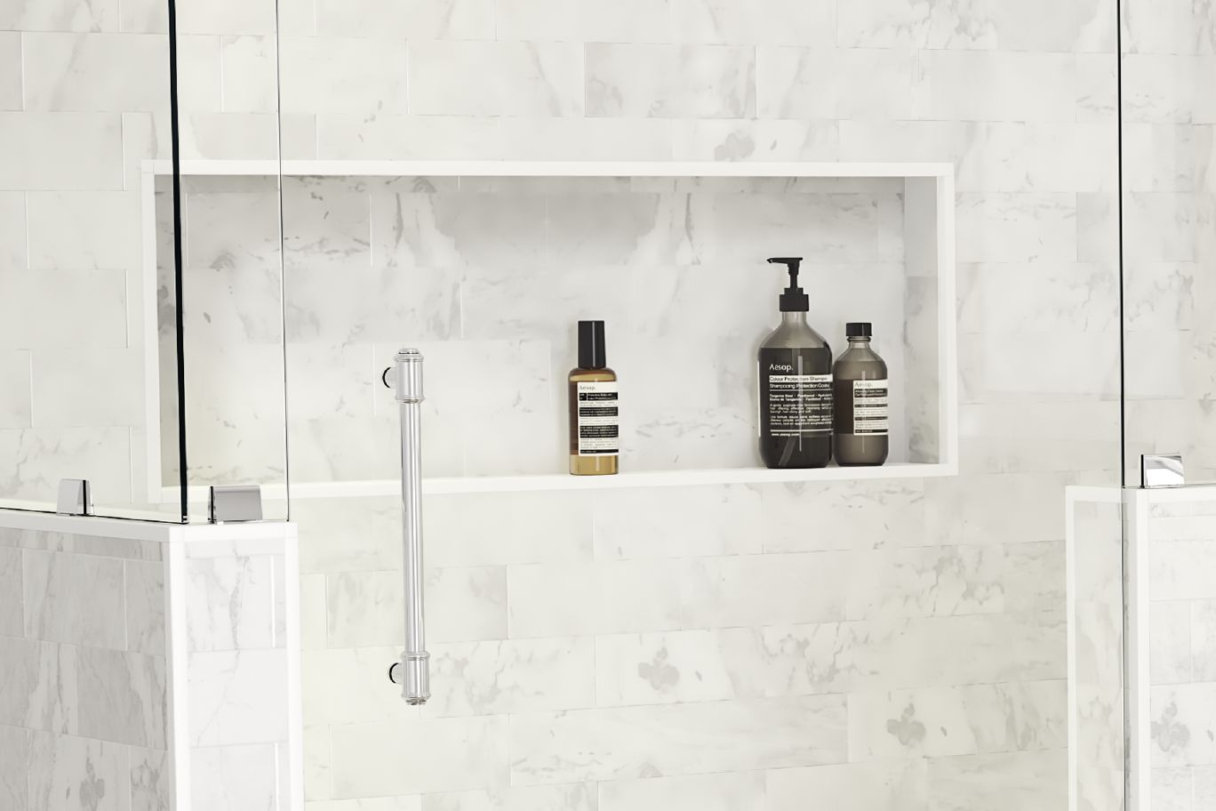  A standing shower with a large white marbled shower niche holding shampoo, conditioner and body wash bottles.